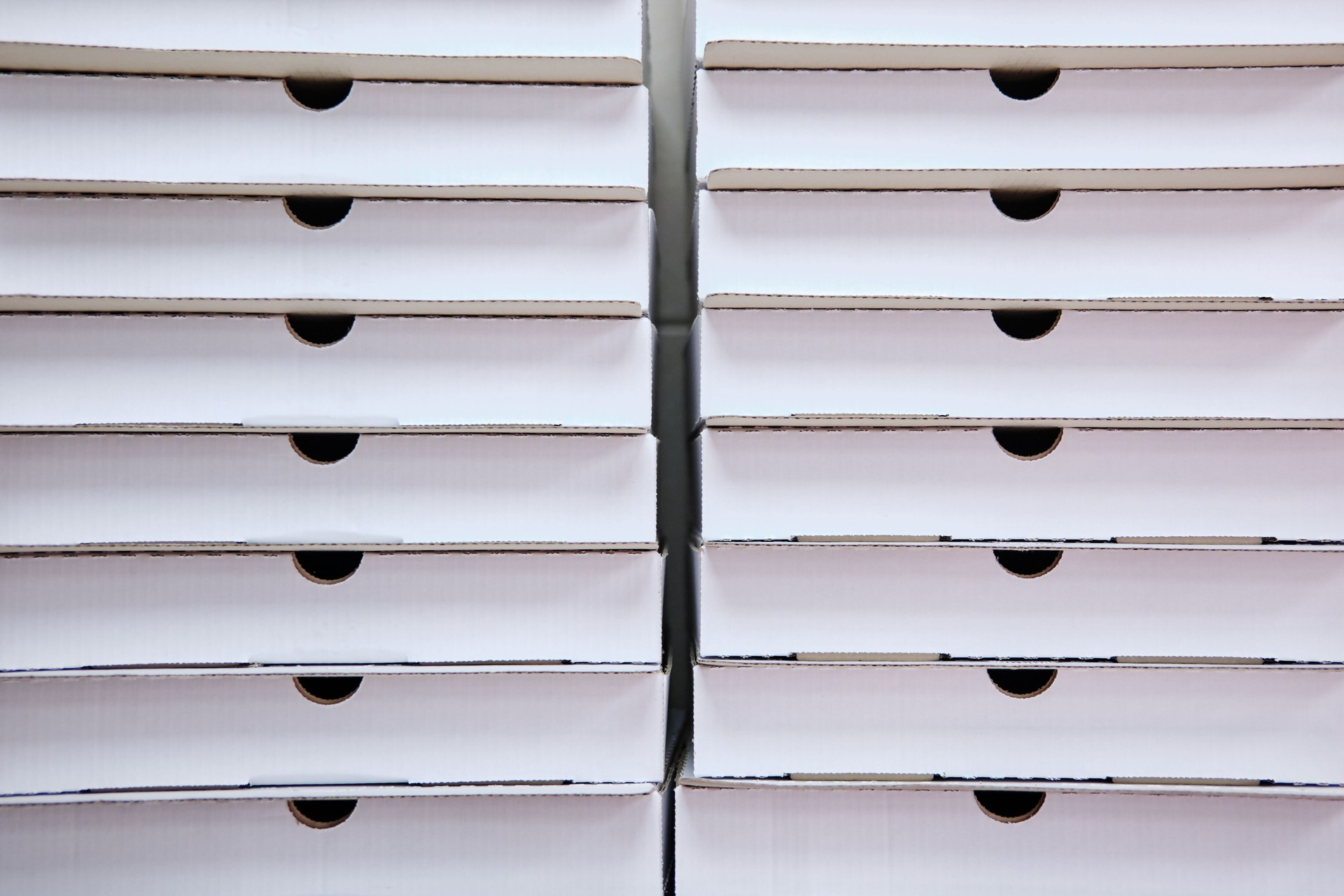Two stacks of empty pizza boxes